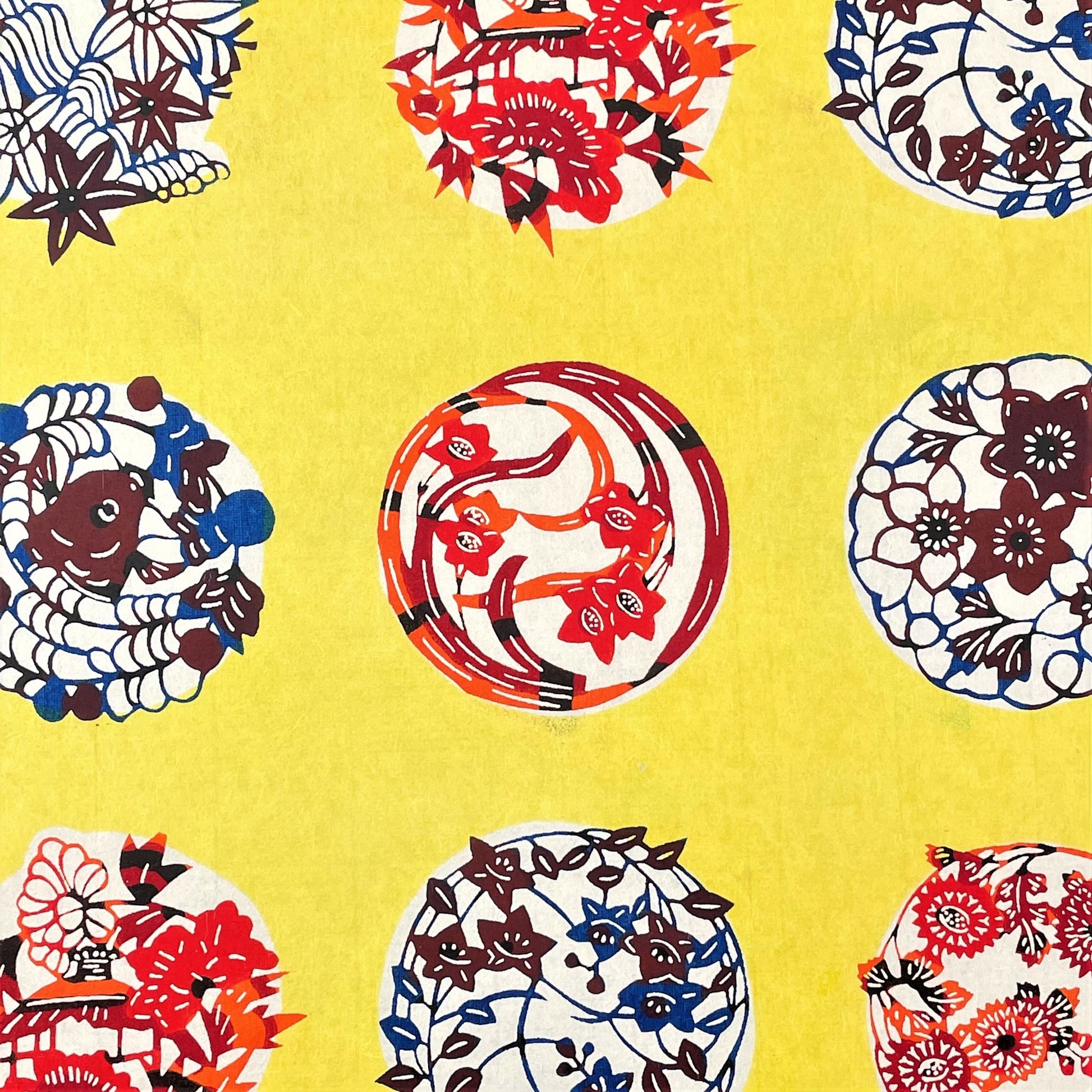 japanese stencil-dyed handmade paper with traditional botanical circles pattern on yellow backdrop