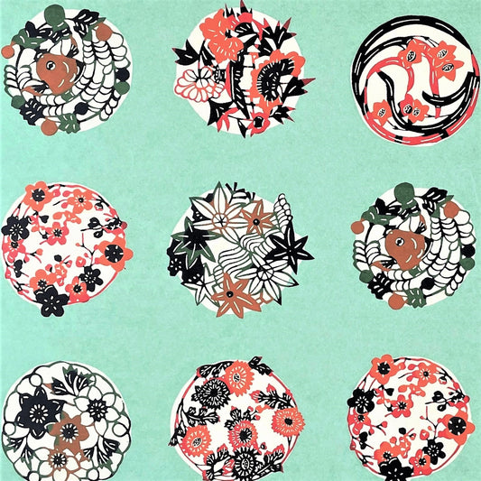 japanese stencil-dyed handmade paper with traditional botanical circles pattern on aqua backdrop