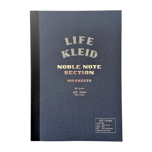A5 softcover notebook with grid pages. The cover is dark blue with a white grid, black spine and branding in silver.  By Japanese brand Kleid