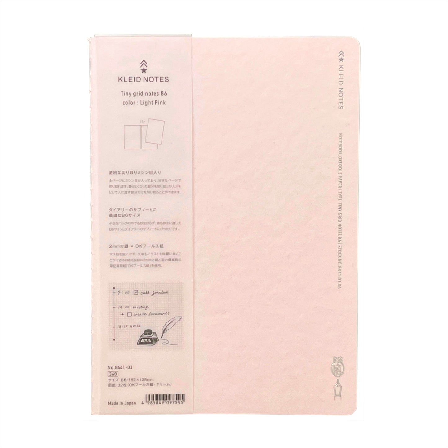 Soft cover notebook with grid format pages. Cover is plain light pink with branded belly band