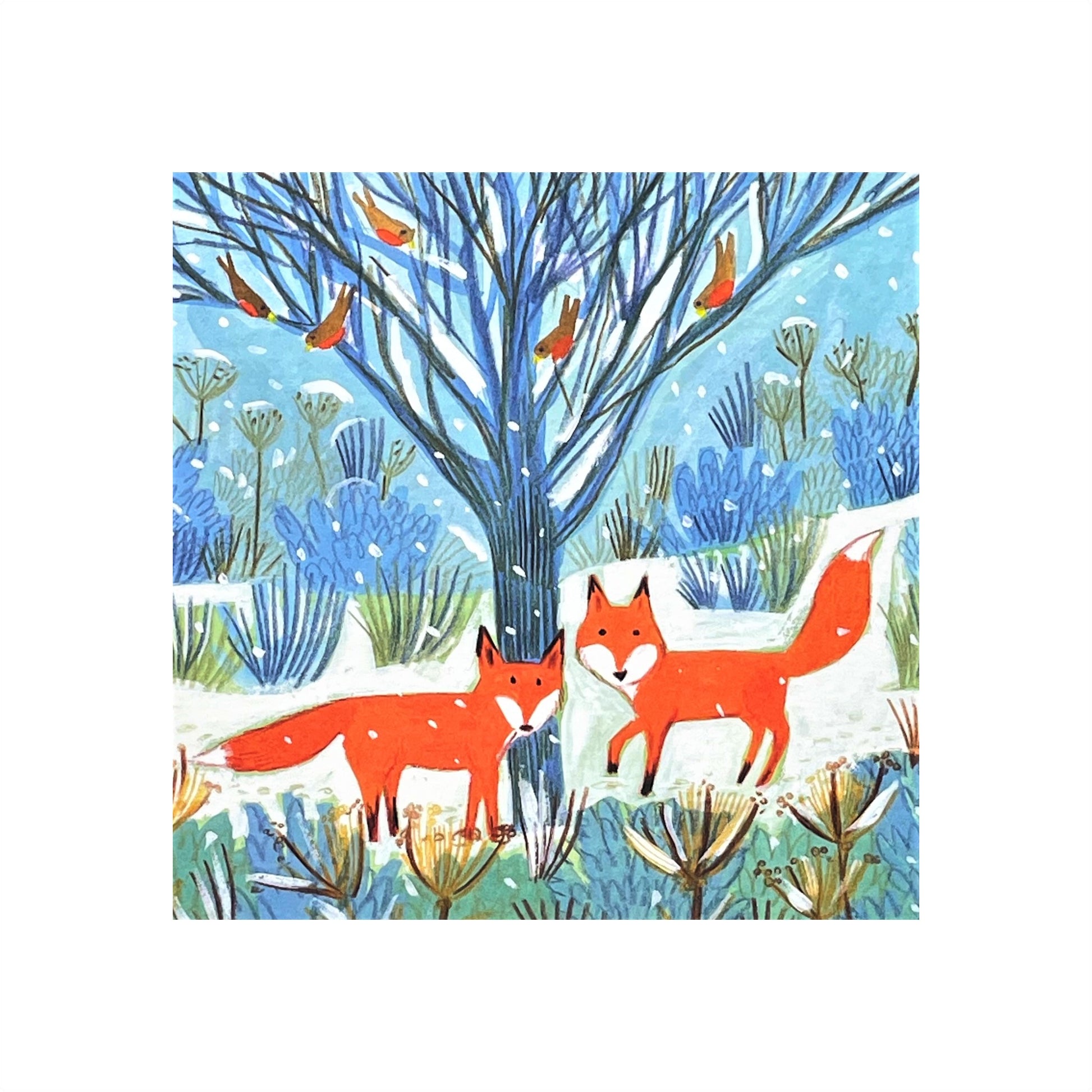 greetings card showing two bright orange foxes under a tree with robins in a snowy landscape