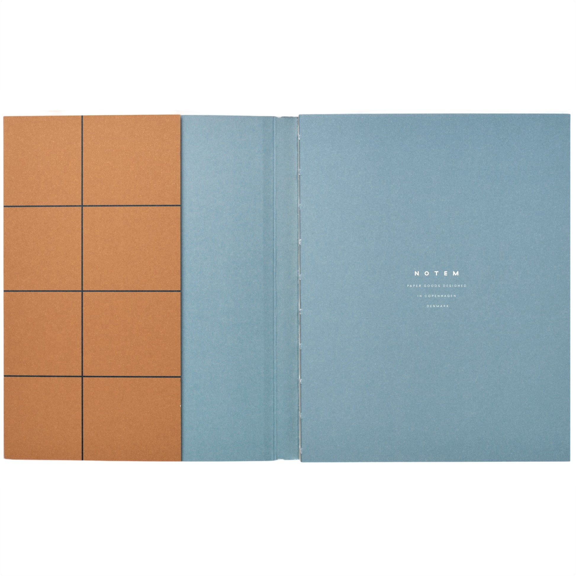 Layflat notebook with dark ochre softcover with black grid lines, pictured open