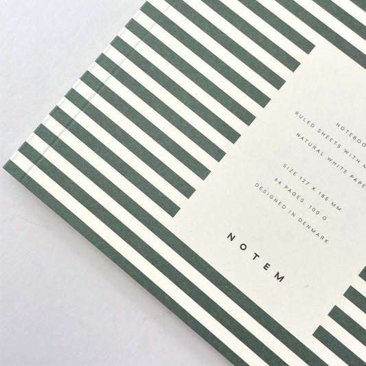 Pocket size notebook with a narrow dark green and white stripe softcover, close-up