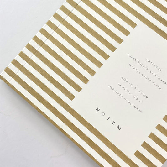 Pocket size notebook with a narrow mustard and white stripe softcover, close-up