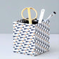 Square pencil pot covered in geometric triangle and dot pattern, navy and gold, patterned paper
