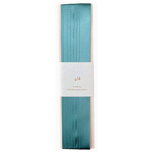 Luxury calamine blue satin ribbon on a rectangular board by Ola Studio
