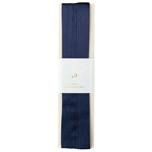 Luxury dark navy satin ribbon on a rectangular board, by Ola Studio