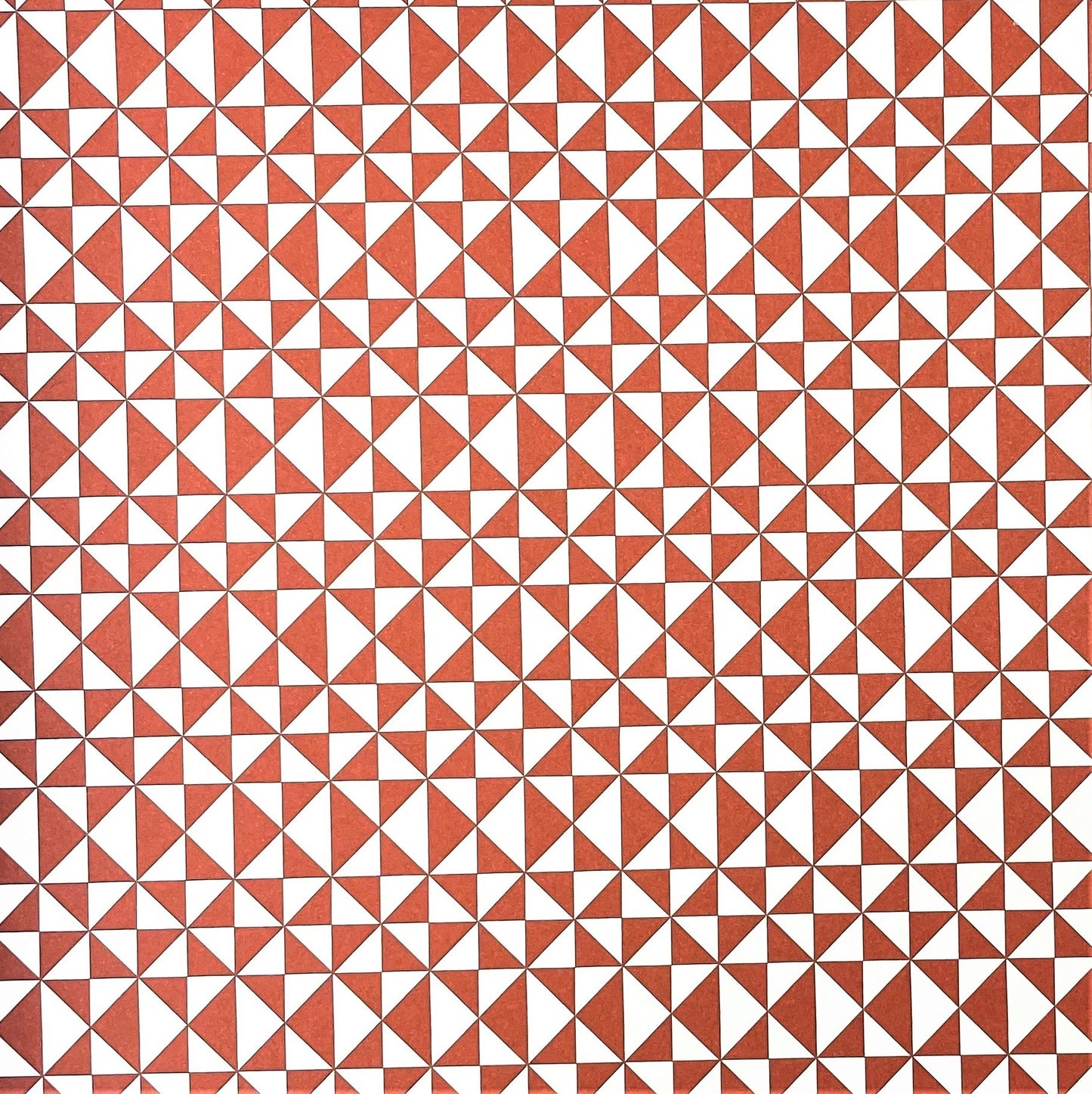 wrapping paper with an abstract triangle pattern in brick red and white by Ola Studio