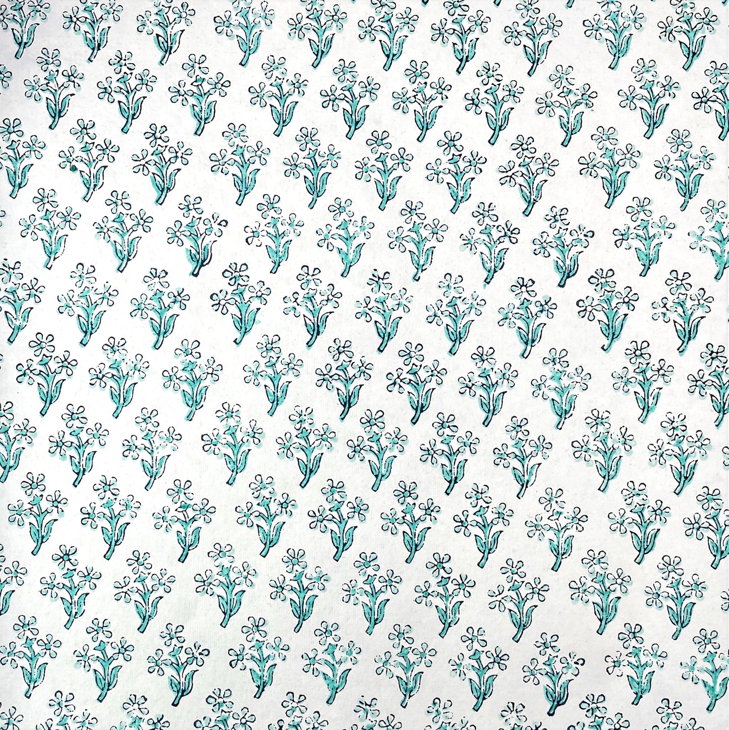 wrapping paper with repeat block print little floral pattern in aqua by Paper Mirchi