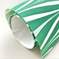 wrapping paper with marbled chevron pattern in green and white, close-up