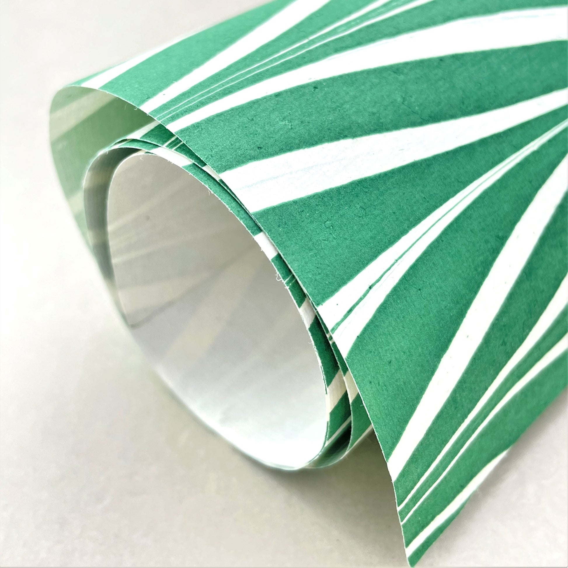 wrapping paper with marbled chevron pattern in green and white, close-up