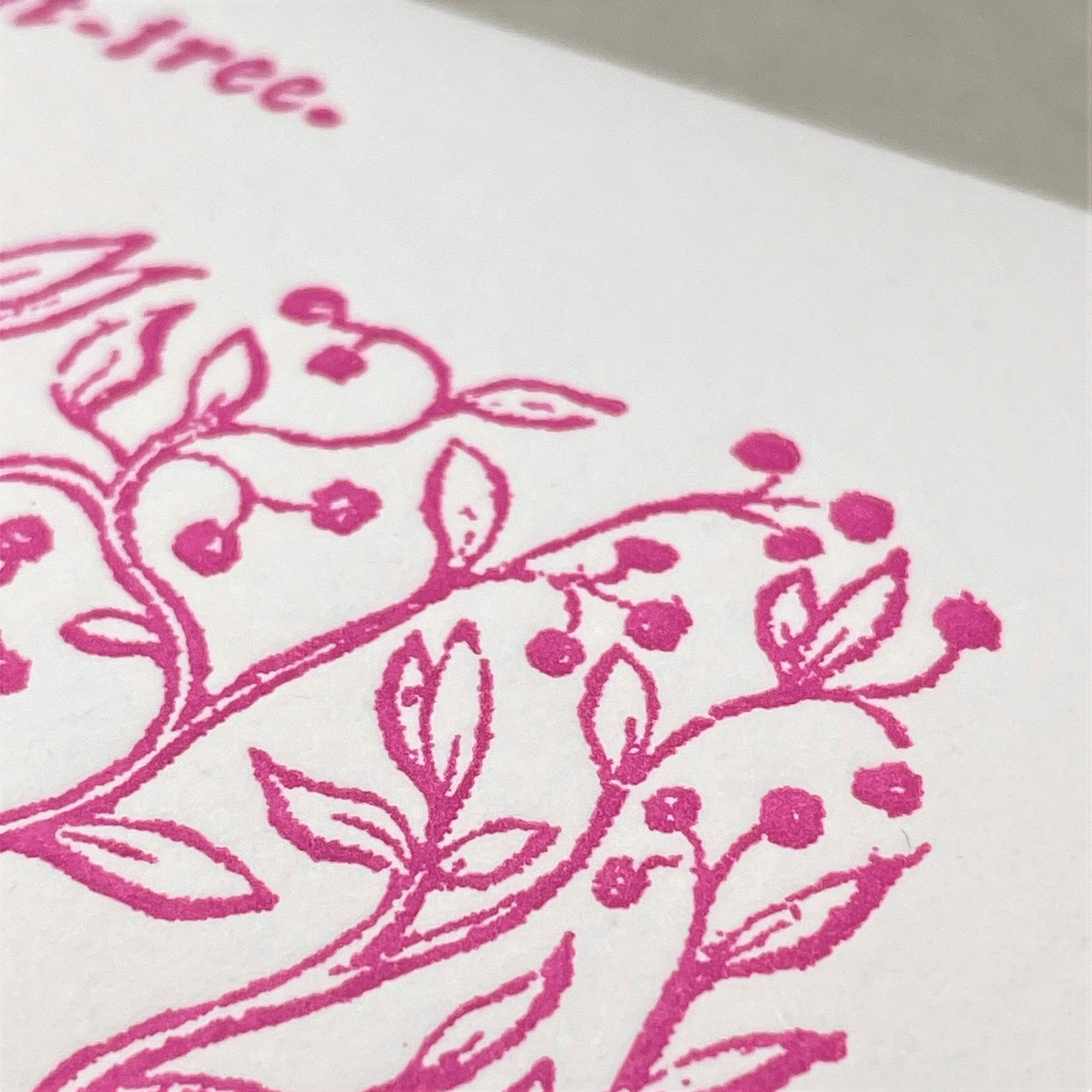 letterpress greetings card of a drawing of a fruit tree, pink ink on white, close-up
