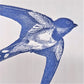 letterpress greetings card of a drawing of a swallow in flight, blue ink on white, close-up