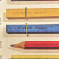 greetings card with drawing of colourful pencils and chalks, close-up