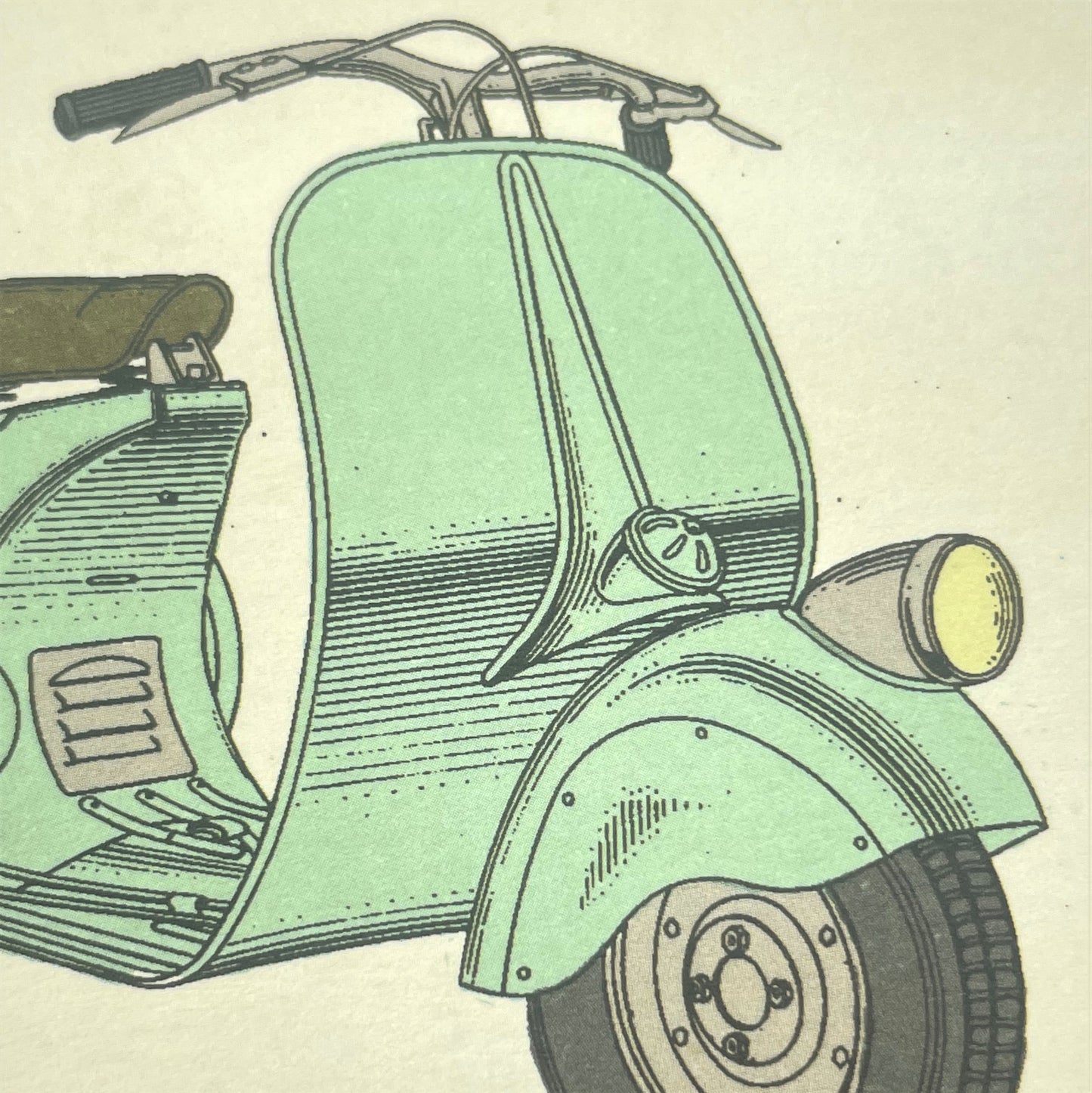 greetings card with drawing of a light green vespa motor bicycle, close-up