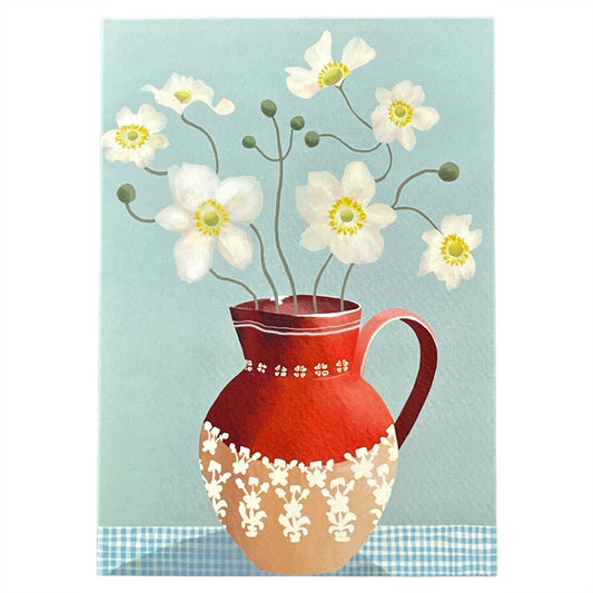 greeting card of a painting of white anemones in in red jug, against a pale blue background by Susie Hamilton